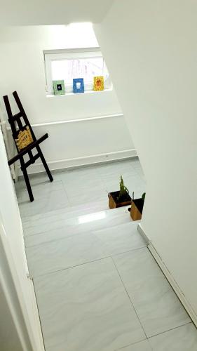 a room with a staircase with a chair and a window at Gago Apartments in Struga