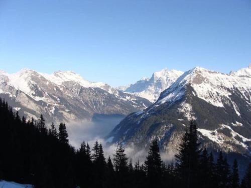 a view of a mountain range with snow covered mountains at Charming Penthouse in Lauterbrunnen