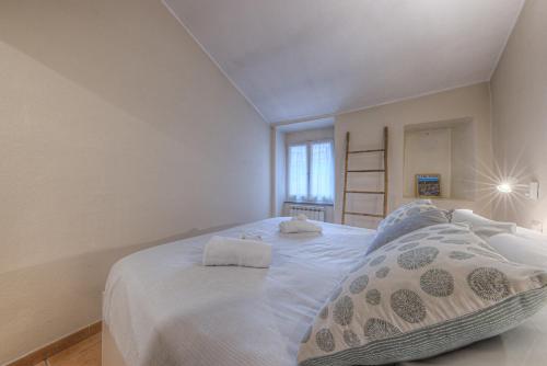 a bedroom with a large white bed with two pillows at Oro by PortofinoHomes in Rapallo