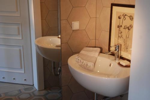 a bathroom with a sink and a toilet and a mirror at Nad Młynówką in Opole