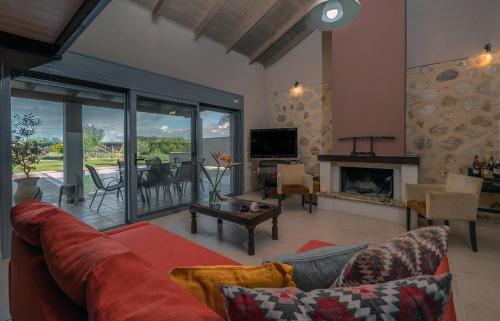 a living room with a couch and a fireplace at Villa Manolia in Preveza