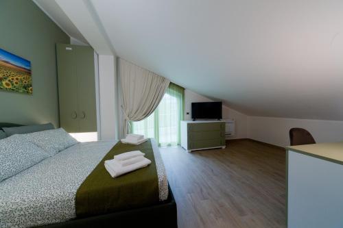 a bedroom with a bed with two towels on it at Slow Chic Apartment BeB Policlinico in Messina
