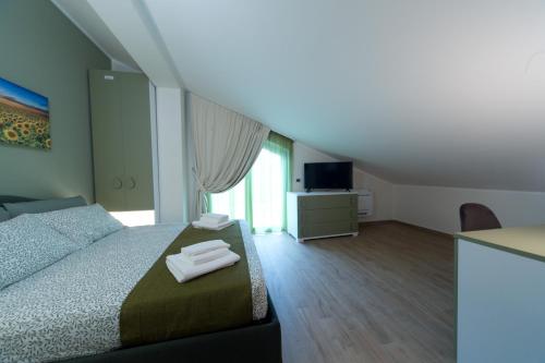 a bedroom with a bed with two towels on it at Slow Chic Apartment BeB Policlinico in Messina