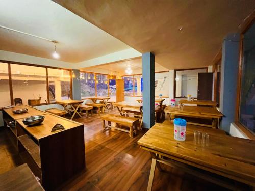 a living room with wooden tables and a pool table at Riverdale Resort, Manali - A Riverside Resort in Manāli