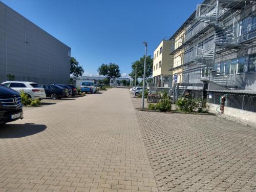 a brick sidewalk in front of a parking lot at Airport Park Hotel MUC in Hallbergmoos