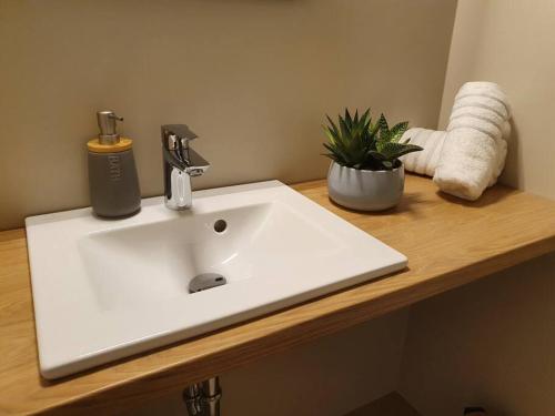 a white sink on a counter in a bathroom at Petra - Official 4* One Bedroom Apartment-Balcony in Zagreb