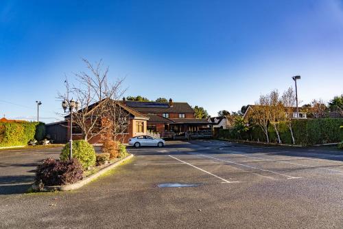 a parking lot with a car parked in front of a building at Golf Links House in Newcastle
