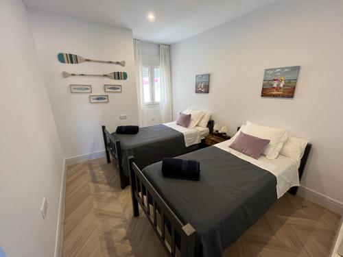 two beds in a small room with at Mirador de Sanlucar 9 in Sanlúcar de Barrameda
