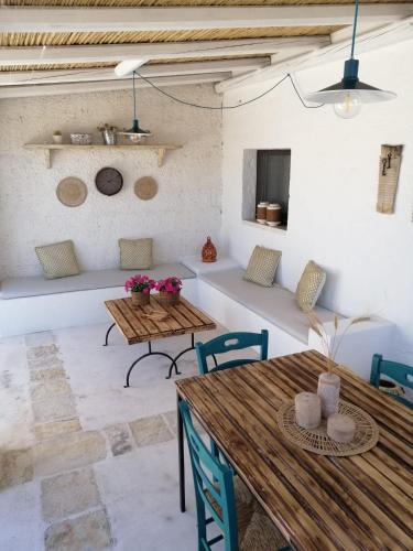 a living room with wooden tables and chairs at Intornoalnoce in Cisternino