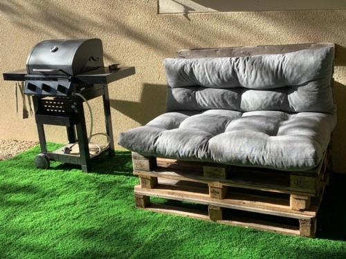 a couch sitting on top of a green carpet at Studio climatisé et tout équipé in Saint-Didier