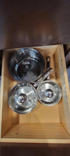 two frying pans sitting on top of a wooden shelf at Cattaraugus, Home sweet home! in Cattaraugus