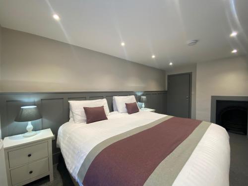 um quarto com uma cama grande e uma lareira em The Old Gables em Brampton