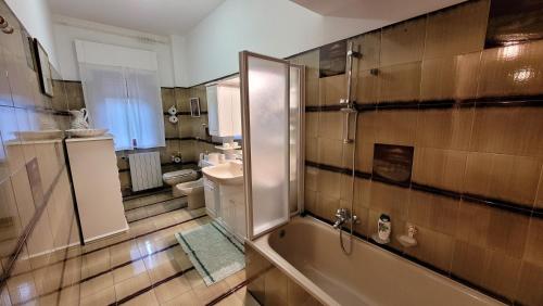 a bathroom with a shower and a sink and a tub at La casa di nonna Carmelina in Milazzo