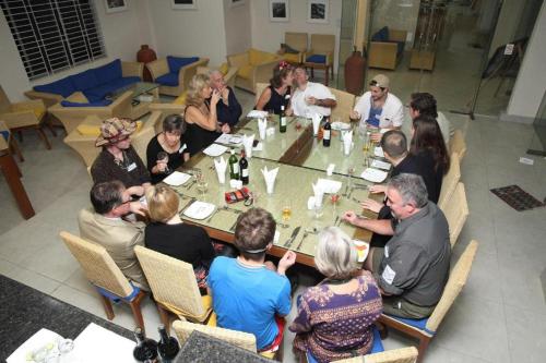 a group of people sitting around a table at Cox's Bazar Surf Club Resort & Cafe in Cox's Bazar
