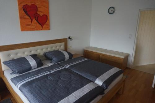 a bedroom with a bed with two pillows on it at Ferienwohnung König in Dornstadt