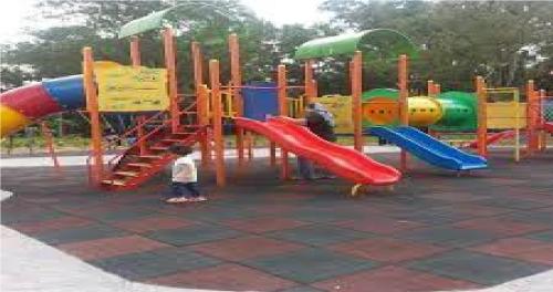 a child standing in front of a playground at Homestay Tengku Maheran in Jitra