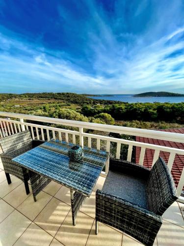 a table and chairs on a balcony with a view of the ocean at B&B Paradiso - Pakleni Islands Hvar in Hvar