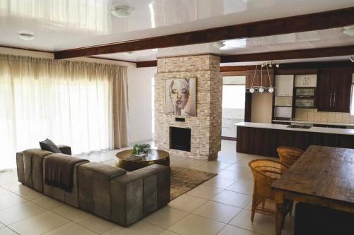a living room with a couch and a fireplace at Serendipity Boutique Guest house in Welkom