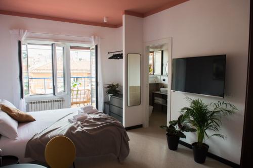 a bedroom with a bed and a flat screen tv at Le Terrazze del Duca San Pietro Guesthouse in Rome