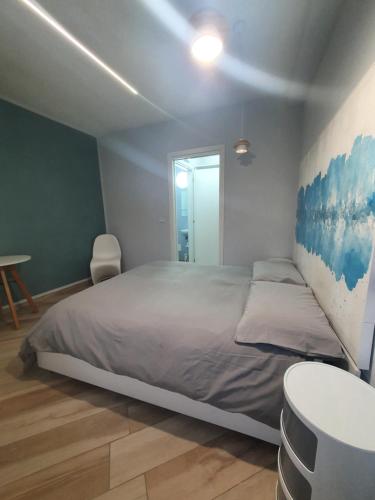 a bedroom with a large bed and a table at Il Giramondo in Busca
