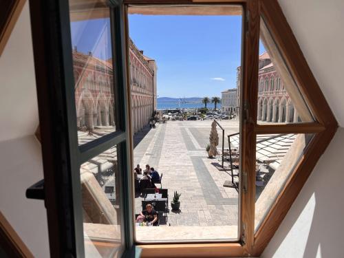 a view of a city from a window at On the Square Suites in Split