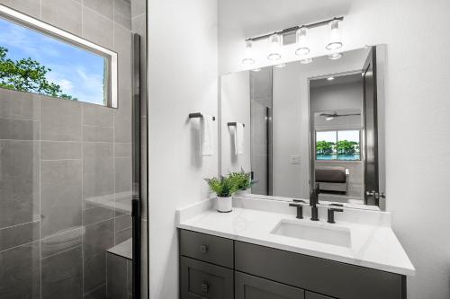 a white bathroom with a sink and a mirror at Highland Harmony New Listing Intro Pricing in Highland Haven