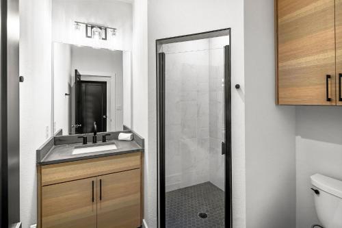 a bathroom with a shower and a sink and a mirror at Highland Harmony New Listing Intro Pricing in Highland Haven