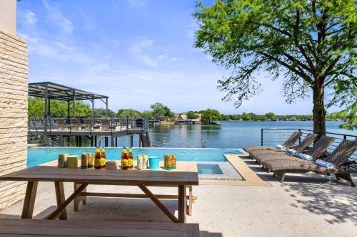 a table with drinks on it next to a swimming pool at Highland Harmony New Listing Intro Pricing in Highland Haven