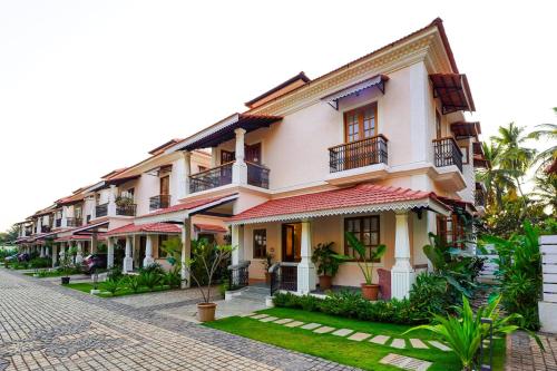 a building with balconies on a street at Elivaas Celest Luxe 4BHK Villa with Pvt Pool near Baga in Old Goa