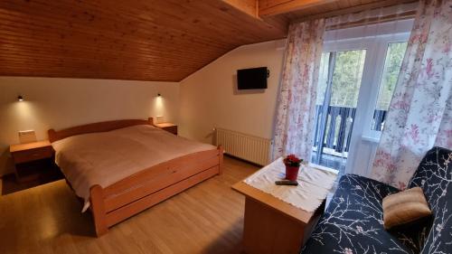 1 dormitorio con cama y ventana grande en Alaska en Wisła