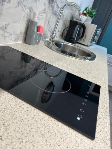 a kitchen counter with a sink and a sink at Market View 1 in Hexham