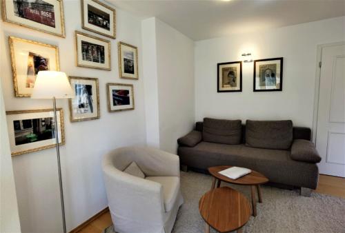 a living room with a couch and a chair at Ferienwohnung Seestern in Bad Saarow