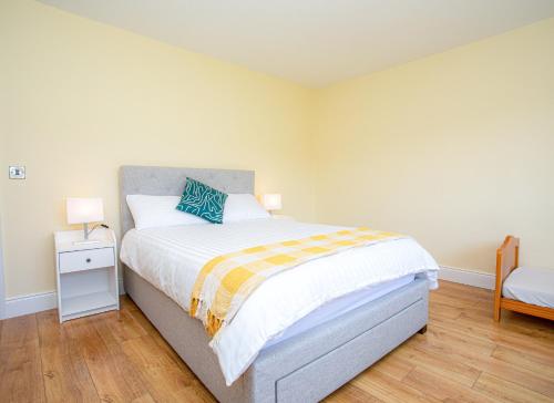 a bedroom with a bed with a blue pillow on it at Lakeview Waterville Holiday Home in Waterville