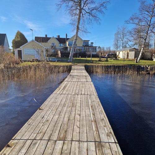a wooden bridge over a body of water at Toftastrand Hotell in Växjö