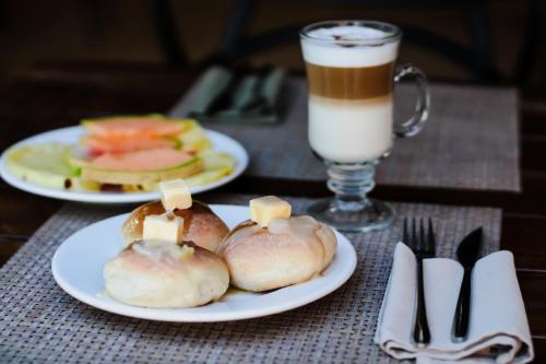 two plates of food on a table with a drink at AGAM Hotel Boutique Bacalar - Adults Only in Bacalar