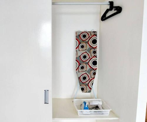 a mirror hanging on a wall in a bathroom at Maya empire studio in Kampong Bukit Lanjan