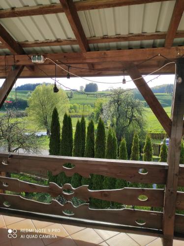 a view of a garden from the porch of a house at Zielona Dolina in Rutka Tartak