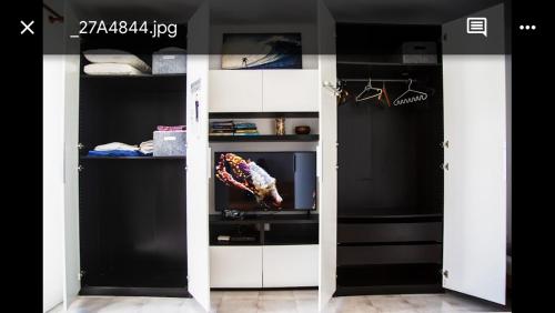 a room with a closet with a door open at OasisstudioLanzarote in Puerto del Carmen