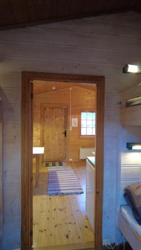 a room with a door in a wooden cabin at Sæbø Camping in Eidfjord