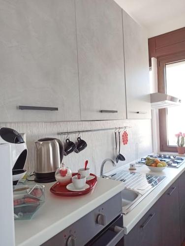 a kitchen with white cabinets and a counter top at B&b da Teresa in Castelsaraceno