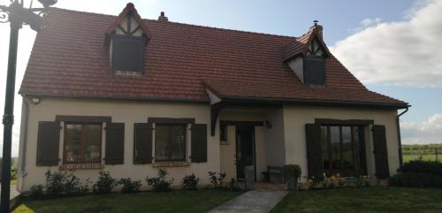 a small white house with a red roof at La Chambre du Valois in Cuvergnon