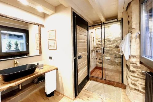 a bathroom with a sink and a shower at Romantic home stone with amazing view lake of Como and Oleandra in Laglio