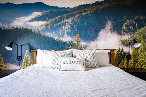 a bedroom with a large bed with a mountain backdrop at Beautiful & Bright 3 Bed Townhome Near Village in Blue Mountains