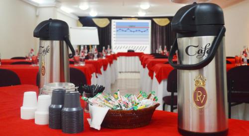 a conference room with red table cloth and two coffee machines at Hotel Plaza Versalles in Cali