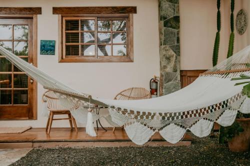 a hammock in the living room of a house at Sansara Surf Yoga & Resort in Cambutal