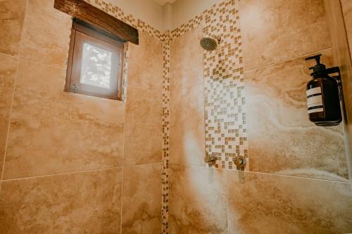 a bathroom with a shower with a window at Sansara Surf Yoga & Resort in Cambutal