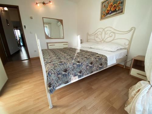 a bedroom with a bed and a mirror at VILLA MARE in Supetar
