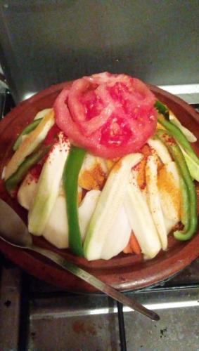 a plate of food with a tomato on top at Maison D'hôtes Chez Bassou Agoudal in Agoudal