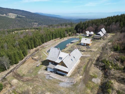 an aerial view of a house on a hill with a river at Fifth Element Retreat in Borzont