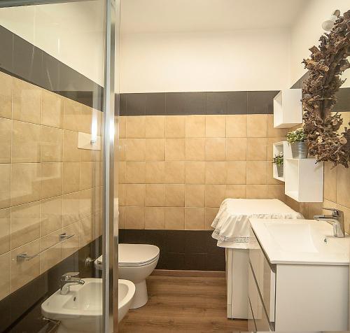 a bathroom with a toilet and a sink at Lake View 30 in Sulzano